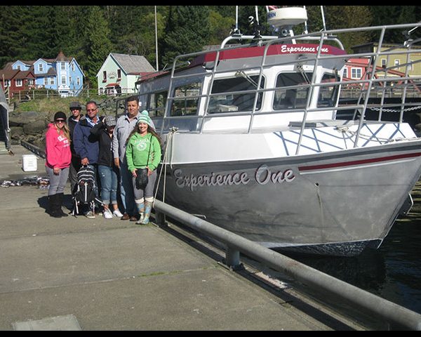 Experience One Vacation people standing next to boat