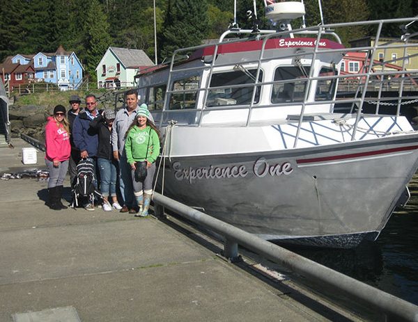Experience One Vacation people standing next to boat