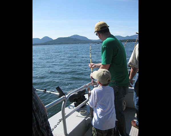 Family Fishing man and boy on boat