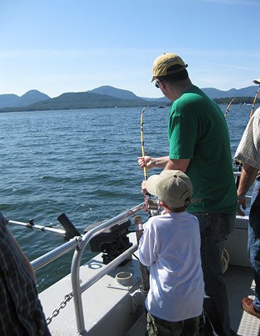 Family Fishing man and boy on boat