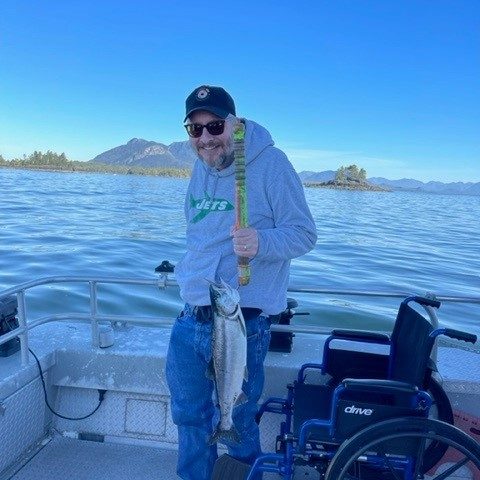 man on boat with fish