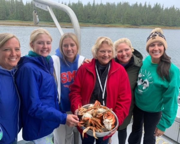 ladies holding a basket with crab legs