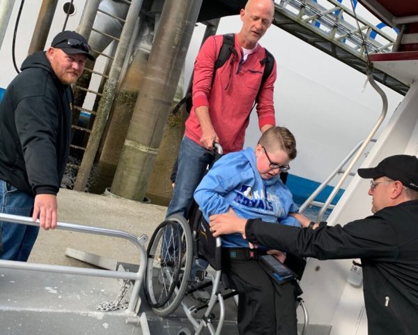 person in wheelchair getting